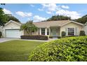 Single-story home with a landscaped yard and garage at 4907 Tara View Rd, Leesburg, FL 34748