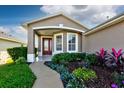 House exterior showcasing a welcoming front porch and landscaping at 5803 Blue Savannah Dr, Leesburg, FL 34748