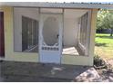 Screened porch with white door and tile flooring at 11450 Lakeview Dr, Leesburg, FL 34788