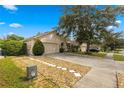 One-story home with a landscaped yard at 30549 Pga Dr, Sorrento, FL 32776