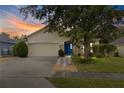One-story home with a landscaped yard at 30549 Pga Dr, Sorrento, FL 32776