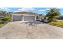 Luxury home with a three-car garage and a circular driveway at 5701 Blanchard Ln, The Villages, FL 32163