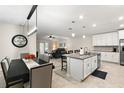 Open concept kitchen with island, stainless steel appliances, and white cabinetry at 5120 Tanzanite Dr, Mount Dora, FL 32757