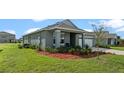 Gray one-story house with white garage door at 1565 Tali Ln, Mount Dora, FL 32757