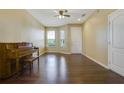 Spacious living room with hardwood floors and a piano at 34416 Tuscany Ave, Sorrento, FL 32776