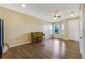 Spacious living room with hardwood floors and a piano at 34416 Tuscany Ave, Sorrento, FL 32776