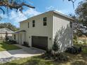 Two-story home with a charming front porch, attached garage, and well-maintained landscaping at 12332 Basin St, Clermont, FL 34715