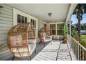 Inviting porch with wicker chairs and lush greenery at 1515 E Washington Ave, Eustis, FL 32726