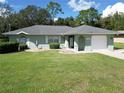 Single story home with attached garage and landscaped yard at 11974 Se 84Th Ave, Belleview, FL 34420