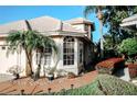 Landscaped exterior with a walkway leading to the home's entrance at 9015 Heathland Ct, Mount Dora, FL 32757