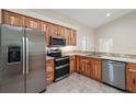 Modern kitchen with stainless steel appliances and wood cabinets at 8222 Florida Boys Ranch Rd, Groveland, FL 34736