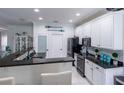 Modern kitchen with white cabinets, granite counters, and island at 615 Del Pilar Dr, Groveland, FL 34736