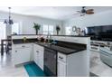 Open concept kitchen with granite island and breakfast bar at 615 Del Pilar Dr, Groveland, FL 34736