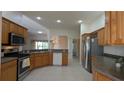 Spacious kitchen with oak cabinets, stainless steel appliances, and ample counter space at 17755 Se 85Th Ellerbe Ave, The Villages, FL 32162