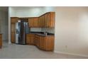Kitchen features oak cabinets, stainless steel appliances, and tile flooring at 17755 Se 85Th Ellerbe Ave, The Villages, FL 32162