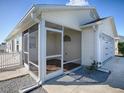 Enclosed screened porch with vinyl flooring and adjacent to garage at 1730 Arnold Rd, The Villages, FL 32163