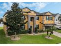 Beautiful two-story house with a yellow exterior, brown accents, and a two-car garage at 349 Morning View Dr, Winter Garden, FL 34787