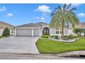 Two-car garage and nicely landscaped front yard at 3024 Hicks Pl, The Villages, FL 32163