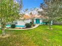 Home exterior with copper roof and lush green lawn at 4750 Sw 95Th Ln, Ocala, FL 34476