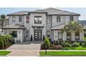 Modern two-story home with gray brick exterior at 16820 Bolsena Dr, Bella Collina, FL 34756