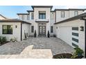 Modern two-story home with gray brick exterior at 16820 Bolsena Dr, Bella Collina, FL 34756