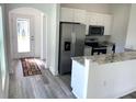 Modern kitchen with granite countertops and stainless steel appliances at 15877 Se 98Th Ct, Summerfield, FL 34491