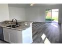Kitchen with granite countertops and island, open to living area at 15877 Se 98Th Ct, Summerfield, FL 34491