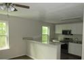Renovated kitchen featuring stainless steel appliances and a breakfast bar at 214 W Dade Ave, Bushnell, FL 33513