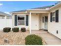 Inviting exterior with a well-maintained lawn and a covered entryway at 983 Smyrna St, The Villages, FL 32162