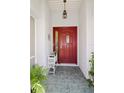Inviting entryway with red door and tiled floor at 4809 Saint Andrews Arc, Leesburg, FL 34748