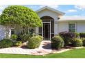 Well-maintained home with landscaped front yard and inviting entryway at 4809 Saint Andrews Arc, Leesburg, FL 34748