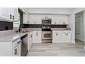 Modern kitchen with white cabinets and stainless steel appliances at 6607 Kreidt Dr, Orlando, FL 32818