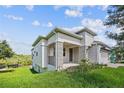 Modern home with stone accents and a covered porch at 1180 Dora Parc Ln, Mount Dora, FL 32757