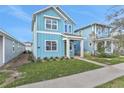 Two-story light blue home with green door and walkway at 3018 Mirage Pl, St Cloud, FL 34771
