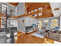 Open living room with high ceilings, wood floors and a spiral staircase at 7373 Circle Dr, Lady Lake, FL 32159