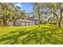 Spacious backyard with detached garage and lush greenery at 7373 Circle Dr, Lady Lake, FL 32159