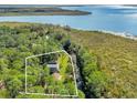 Aerial view of a waterfront home nestled in a wooded area at 7373 Circle Dr, Lady Lake, FL 32159