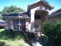 House exterior showcasing a front entrance and landscaping at 8527 Firestone Cir, Clermont, FL 34711