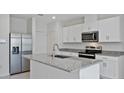 Modern kitchen with stainless steel appliances and granite countertops at 1496 Mirabella Cir, Davenport, FL 33897