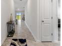 Bright and spacious entryway with tile flooring and a modern console table at 656 Daring Dr, Davenport, FL 33837