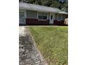 Ranch style home with brick and gray siding, featuring a spacious yard at 620 Gould St, Eustis, FL 32726