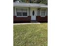House front view, featuring a gray exterior, and a well-maintained lawn at 620 Gould St, Eustis, FL 32726