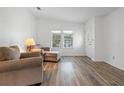 Bright living room featuring laminate flooring and comfy seating at 1020 Hilltop Rd, Tavares, FL 32778