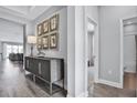 Entryway with hardwood floors, modern console table, and framed artwork at 15615 Vetta Dr, Montverde, FL 34756