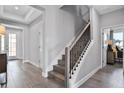 Elegant staircase with dark wood treads and black metal balusters at 15615 Vetta Dr, Montverde, FL 34756