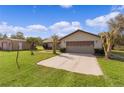 View of the home's attached garage and driveway at 593 Nw 111Th Ln, Oxford, FL 34484