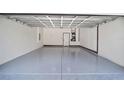 Clean and spacious garage interior with epoxy flooring at 3611 Se 132Nd Pl, Belleview, FL 34420