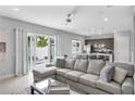 Open living space with sectional sofa and view of kitchen and patio at 7740 Sandy Ridge Dr # 106, Reunion, FL 34747