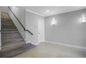 Bright entryway with modern staircase and wood-look flooring at 7740 Sandy Ridge Dr # 106, Reunion, FL 34747