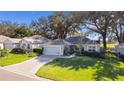 Single-story home with paved driveway and green lawn at 8194 Se 177Th Winterthur Loop, The Villages, FL 32162